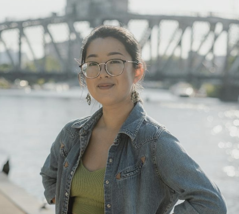 Photo of Zoe Li in front of a river and bridge