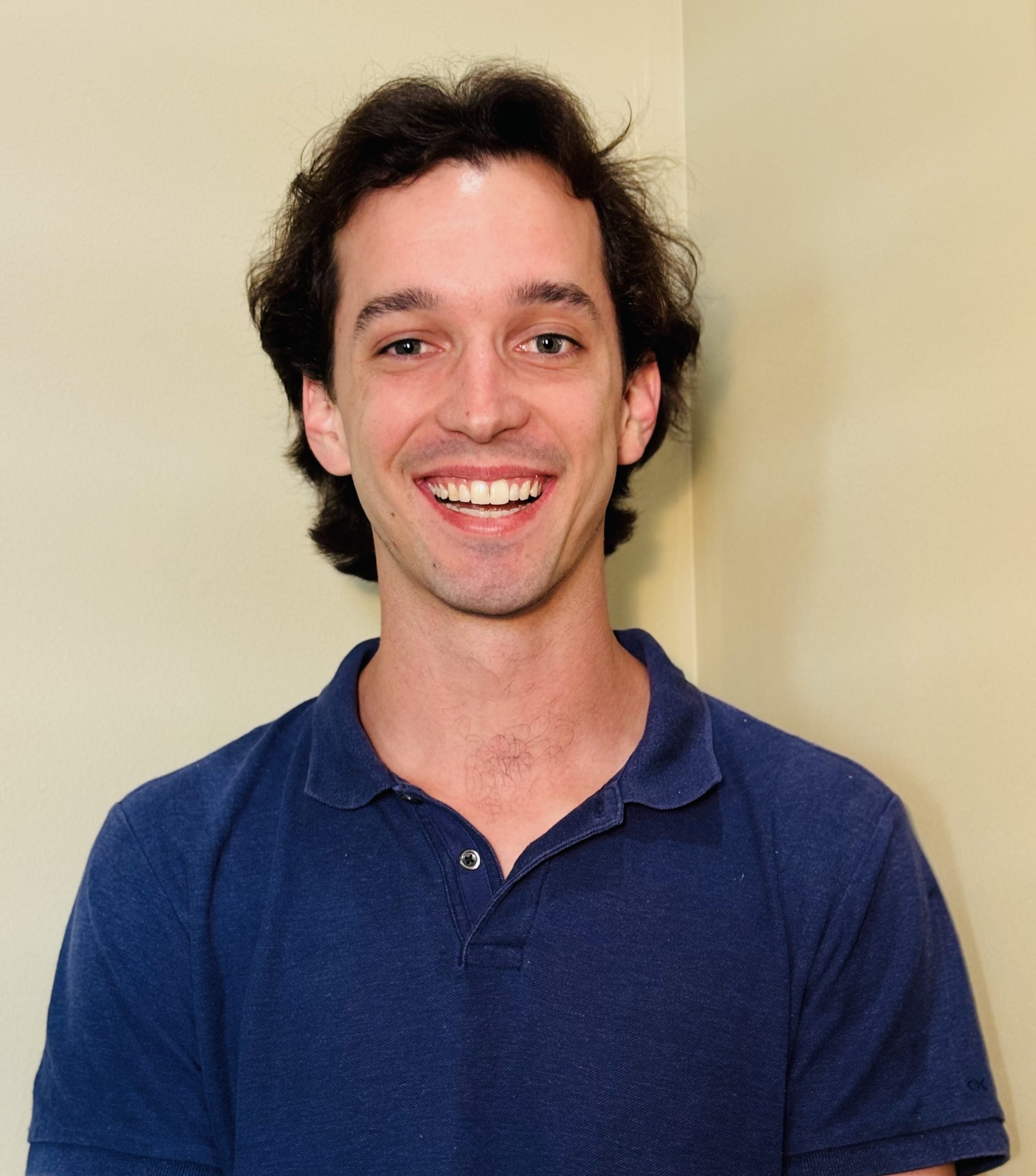 Photo of Jack smiling in a blue collared shirt