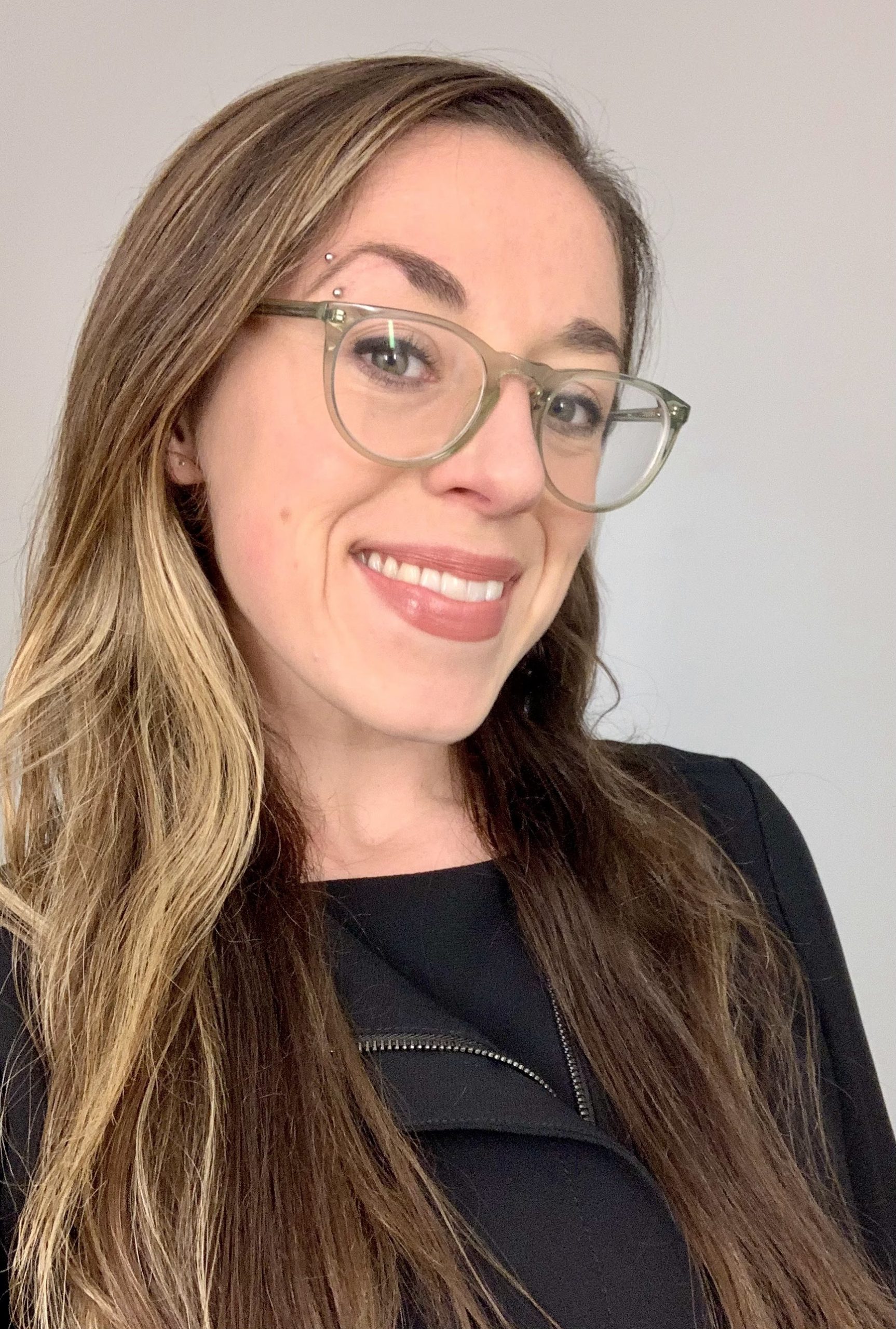 Leah Fessler is pictured smiling in a black blouse.