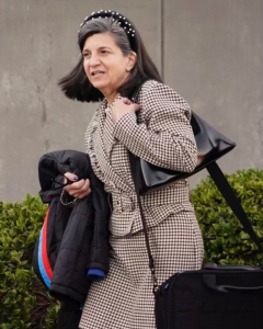 Photo of Stacy Ferraro walking with a bag on her shoulder